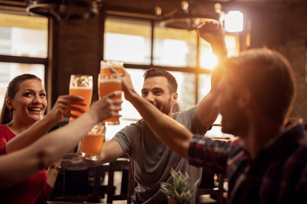 group-happy-young-people-toasting-with-beer-having-fun-pub